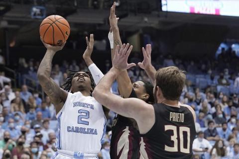 North Carolina guard Caleb Love (2) shoots against Florida State forward Harrison Prieto (30) and guard Caleb Mills during Saturday’s game in Chapel Hill, N.C. (GERRY BROOME/Associated Press)