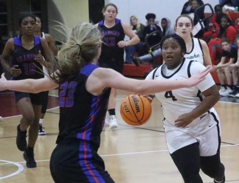 Fort White guard N’Coreyia Atkins pushes the ball up the floor after a steal against Branford during Thursday’s District 6-1A semifinal. (JORDAN KROEGER/Lake City Reporter)