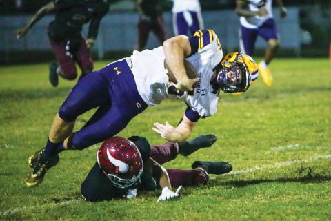 Columbia linebacker Jaden Dunn is tackled after intercepting a pass against Raines this past season. (BRENT KUYKENDALL/Lake City Reporter)