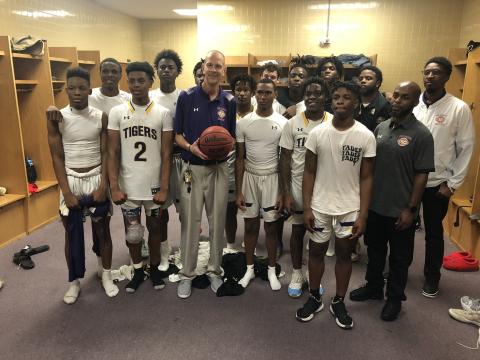Columbia head coach Steve Faulkner is pictured holding the game ball with his team after the Tigers defeated Forest on Wednesday night. (JORDAN KROEGER/Lake City Reporter)