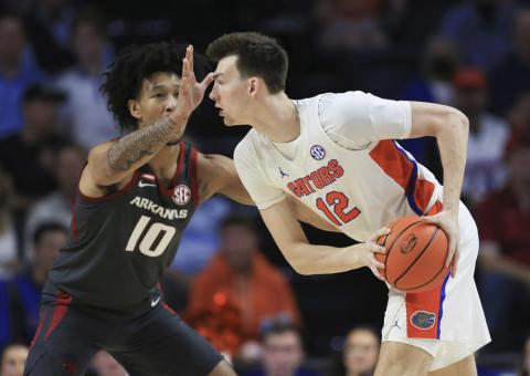 Arkansas forward Jaylin Williams (10) defends against Florida forward Colin Castleton (12) during Tuesday's game in Gainesville. (MATT STAMEY/Associated Press)