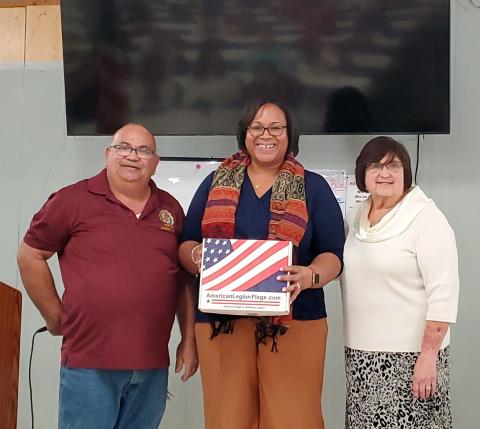 Columbia County Schools Assistant Superintendent Hope Jernigan (center) was presented with new American flags for district schools by American Legion Post Commander Rick Cabrera (left) and Irma Wehrli, Auxiliary Board member. (COURTESY)