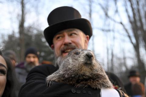 Groundhog Club handler A.J. Dereume holds Punxsutawney Phil, the weather prognosticating groundhog, during the 136th celebration of Groundhog Day on Gobbler’s Knob in Punxsutawney, Pa., on Wednesday. Phil’s handlers said that the groundhog has forecast six more weeks of winter. (BARRY REEGER/Associated Press)