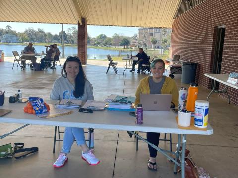 Volunteers sit at a makeshift desk at Wilson Park during a Florida drivers license restoration event. (COURTESY)