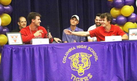 Columbia golfer Zach Shaw (right) reaches for the microphone from teammate Ty Folsom as the two share a laugh during Thursday’s signing ceremony. (MORGAN MCMULLEN/Lake City Reporter)