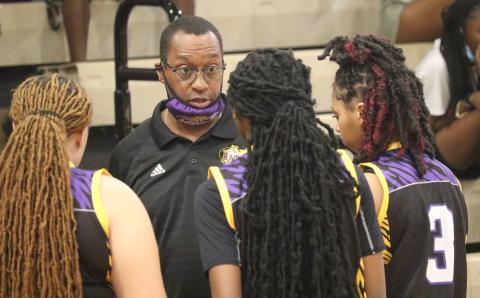 Columbia head coach Anthony Perry talks to guard Na'Haviya Paxton (middle) during a timeout of the District 3-6A championship game against Gainesville on Friday. (JORDAN KROEGER/Lake City Reporter)