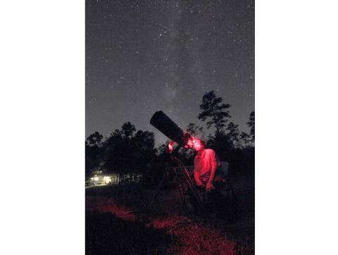 Late astrophotographer Steve Speck sets up his camera and telescope in the night hours. (COURTESY)