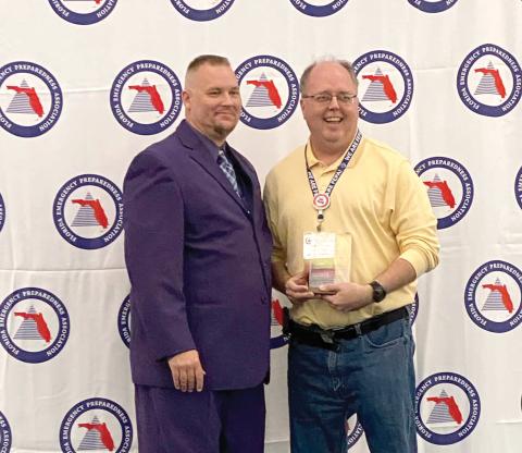 Shayne Morgan (right), Columbia County’s emergency management director, was honored as the Florida Emergency Preparedness Association’s Chad Reed Emergency Management Professional of the Year. (COURTESY)