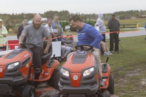 Eugene Hassett (left) of W.B. Howland and Adam Bricker of Farm Credit jockey for position during Saturday’s 24th annual Arc North Florida Lawn Mower Race. (JAMIE WACHTER/Lake City Reporter)