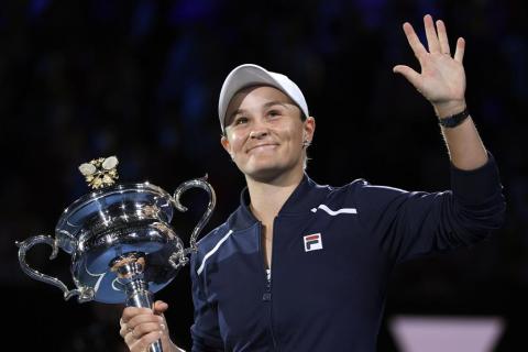 Ash Barty waves as she holds the Daphne Akhurst Memorial Cup after defeating Danielle Collins in the final at the Australian Open on Jan. 29 in Melbourne, Australia. (AP File)