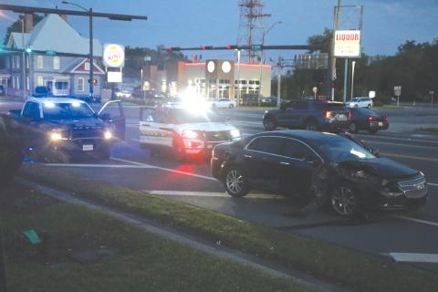 Columbia County Sheriff’s deputies block traffic in one lane heading westbound on U.S. Highway 90 near NW Main Blvd. in front of a wrecked Chevy Malibu on Wednesday night. (MORGAN MCMULLEN/Lake City Reporter)