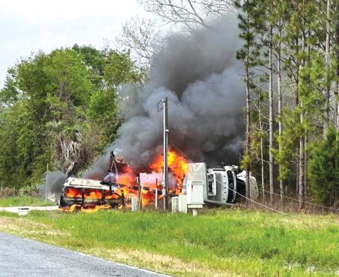 A semi-truck carrying a delivery of liquor burns off the side of County Road 250 near the intersection of 201st Road. (COURTESY)