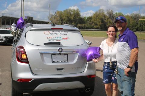 Columbia High welding teacher Darryl Thomas and his wife, Jan, stand with their brand new Buick Encore, a prize Thomas won for being named the Columbia County School District’s Teacher of the Year. (TONY BRITT/Lake City Reporter)