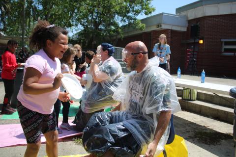 Melrose Park Elementary School student Aylin Alvarez (left) reacts after smearing Assistant Principal Stephen Smithy with a whipped cream pie. (TONY BRITT/Lake City Reporter)