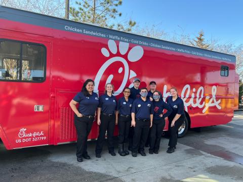 Chick-fil-A associates pose in front of the new food truck that will be serving up fast food treats. (COURTESY)