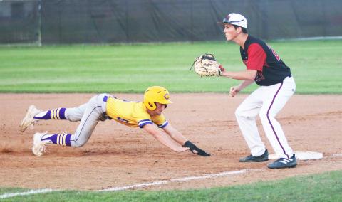 Columbia’s Matt Dumas slides back to first base to beat a pickoff throw during Wednesday’s game against Baker County. (JORDAN KROEGER/Lake City Reporter)