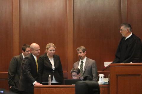 Representatives for both the prosecution and defense — including State Attorney John Durrett (second from left) and defense attorneys Allison Miller (third from left) and Nathan Marshburn (second from right) — and Judge Paul Bryan (right) gather around the court’s stenographer to review a piece of testimony Thursday afternoon at the Columbia County Courthouse. (MORGAN MCMULLEN/Lake City Reporter)