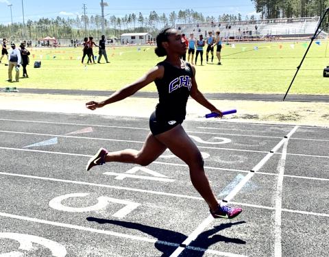 Columbia’s Stacy White crosses the finish line in the 4x100 relay at the Creekside Invitational on Saturday. (DYLAN ASPENWALL/Special to the Reporter)