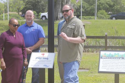 Pilgrim’s Pride’s Brent Lang (right) speaks at Wednesday’s unveiling of Discovery Trail as Suwannee River Regional Library System director Betty Lawrence (left) listens. (JAMIE WACHTER/Lake City Reporter)