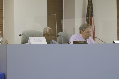 Councilman Eugene Jefferson (left) listens as Todd Sampson speaks during Tuesday’s city council meeting. (JAMIE WACHTER/Lake City Reporter)