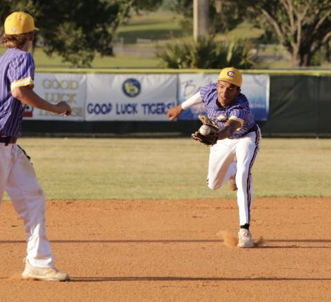 Columbia second baseman Brayden Thomas just misses a ball through the infield during Friday night’s game against Buchholz. (BRENT KUYKENDALL/Lake City Reporter)