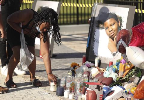 Family and friends of Tyre Sampson leave items during a vigil in front of the Orlando Free Fall drop tower on March 28. (STEPHEN M. DOWELL/Orlando Sentinel/Associated Press)