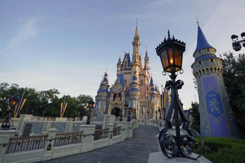 The newly painted Cinderella Castle at the Magic Kingdom at Walt Disney World is seen with the the crest to celebrate the 50th anniversary of the theme park on Aug. 30, 2021. (JOHN RAOUX/Associated Press)