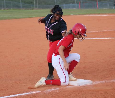 Lafayette’s Jaley Moseley beats a tag from Fort White third baseman N’Coreyia Atkins during Tuesday’s game. (JORDAN KROEGER/Lake City Reporter)