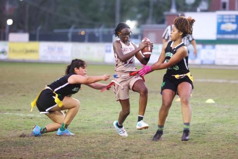 Suwannee’s Amyrah Jones (right) pulls the flag of Florida High’s Rachel White on Wednesday night. (PAUL BUCHANAN/Special to the Reporter)