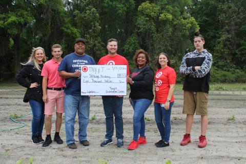 Bobby Brewin (center) with the Lake City Target Distribution Center presents an $8,000 check to Adee Farmer for the Pathways Academy garden. Also present were Dianna Swisher (from left), Brandon Ray, Pathways Principal Makeba Murphy, Nicole Robertson and Joseph Lee Pendleton. (TONY BRITT/Lake City Reporter)