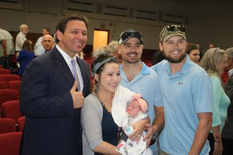 Chance and Chelsie Windham took their three-week-old daughter, Sadie June, to meet Gov. Ron DeSantis on Tuesday during his Jasper visit. Also pictured is Josh Smith (right), a family member. (TONY BRITT/Lake City Reporter)