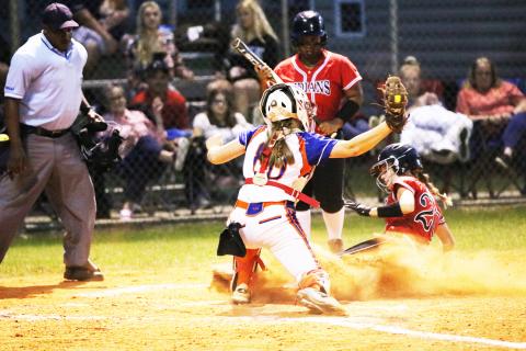 Fort White’s Madalyn Keen slides safely into home plate to beat the tag from Branford catcher Morgan Brennan as N’Coreyia Atkins looks on during Wednesday game. (JORDAN KROEGER/Lake City Reporter)