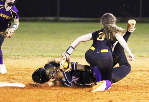 Fort White’s Ciara Byrd is tagged out by Bell’s Michelle Heilig as she tries to steal second base on Thursday night. (MORGAN MCMULLEN/Lake City Reporter)