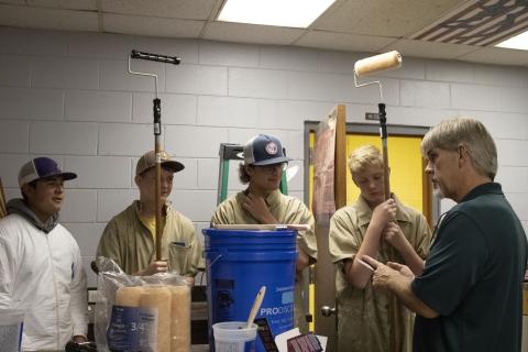 Columbia High building and construction teacher Scott Dockery (right) gives directions to Tyler Moore (from left), Chase Bedenbaugh, Cameron Saunder and Shawn Cuchens as they prepare to begin the painting portion of the shop renovation with painting supplies graciously donated by Sherwin Williams. (COURTESY)