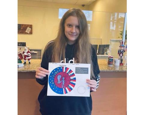 Ridgeview High School student Gracie McCann shows off the winning design in Clay County’s ‘I Voted’ sticker design contest. (COURTESY)