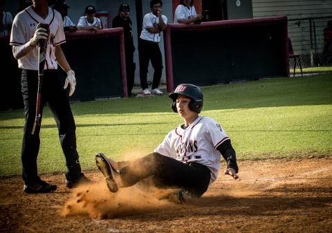 Fort White's Garrett Depaola slides safely into home plate to score a run against Taylor County on Thursday night. (CHRISTINA FEAGIN/Special to the Reporter)