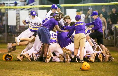 Columbia’s baseball team celebrates in a dogpile after rallying past Lincoln in the bottom of the seventh to win the Region 1-5A title on Monday to advance to the state Final Four. (BRENT KUYKENDALL/Lake City Reporter)