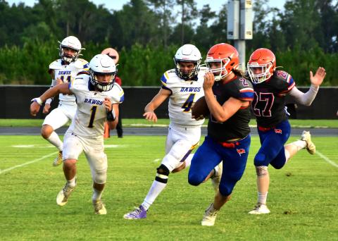 Branford running back Caden Coker rushes up the field against Bell during their spring jamboree on Tuesday. (ROB WOLFE/Special to the Reporter)