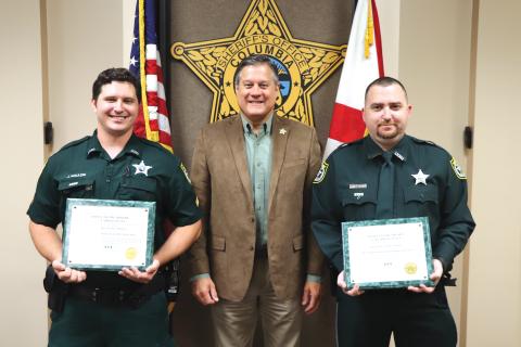 Corporal James Maulden (left) and Detention Officer Mark Collins (right) received ‘Lifesaving Medals’ from Sheriff Mark Hunter on Wednesday. (COURTESY)