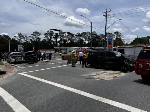 First responders clean up the intersection of SE Baya Drive and State Road 100 on Monday afternoon following a three-vehicle accident, including a Lake City Police Department SUV. (JAMIE WACHTER/Lake City Reporter)