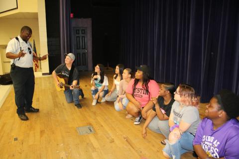 Ronnie Collins (standing), Columbia’s Top Talent founder, talks to final round contestants AJ Busscher (from left), Brynlei Smith, Jailyn Canela, Jalyssa Thomas, Kenzoria Pryor, Kenya Pollock, Keira Fletcher and Cai’Liana Mobley during rehearsal Monday. (TONY BRITT/Lake City Reporter)