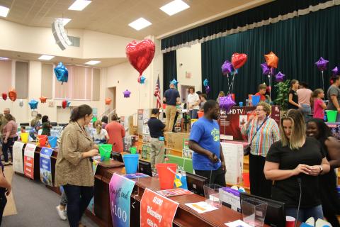 Columbia County School District employees peruse the 500 items in the district auditorium as part of the Employee Appreciation Extravaganza. (TONY BRITT/Lake City Reporter)