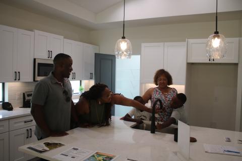 Lennardo Miller (clockwise from left), Pam Miller, Jaxon Miller, Narrie Smith and Brayden Miller, inspect and test kitchen appliances during a Parade of Homes visit on Sunday afternoon. (TONY BRITT/Lake City Reporter)