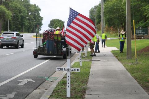 Volunteers with the Republican Party of Columbia County placed crosses and flags with the America’s Heroes program along State Road 47 on Sunday. (TONY BRITT/Lake City Reporter)