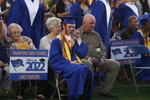 Branford salutatorian Luke Norton wipes away a tear after presenting loved ones with a flower during commencement exercises Friday night at Buccaneer Stadium. (MORGAN MCMULLEN/Lake City Reporter)