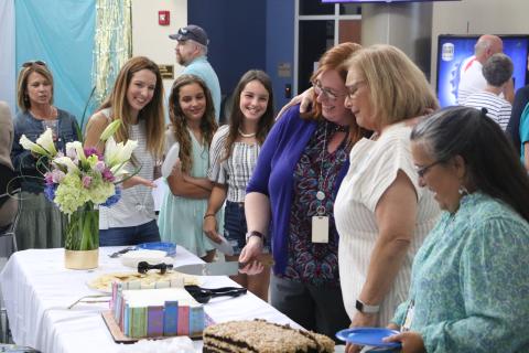 Jo Ann Bailey (second from right) hugs FGC Library Director Christine Boatright alongside Bailey’s daughter Jana Robinson (left) and Bailey’s grandchildren, Hannah and Hailey Robinson. (MORGAN MCMULLEN/Lake City Reporter)