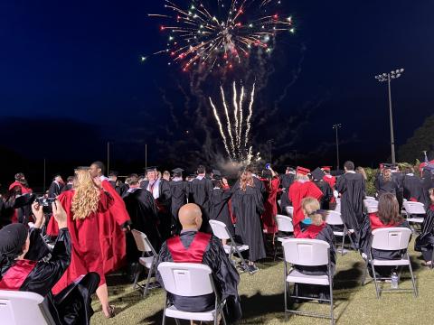 Fort White graduates watch a fireworks display at the end of commencement exercises Friday night at Arrowhead Stadium. (RAY CARPENTER/Special to the Reporter)