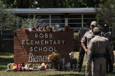 Flowers and candles are placed outside Robb Elementary School on Wednesday in Uvalde, Texas, to honor the victims killed in Tuesday's shooting at the school. (JAE C. HONG/Associated Press)
