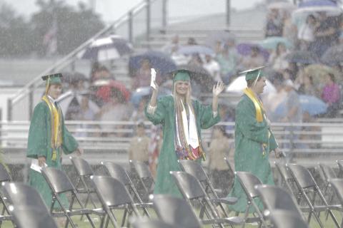 Caroline Simpson, the Suwannee High senior class vice president, walks into Langford Stadium during a downpour Saturday night. (JAMIE WACHTER/Lake City Reporter)