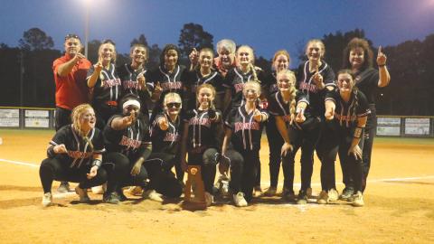 Fort White’s softball team poses with the District 6-1A trophy after defeating Branford 11-0 on Thursday. (MORGAN MCMULLEN/Lake City Reporter)